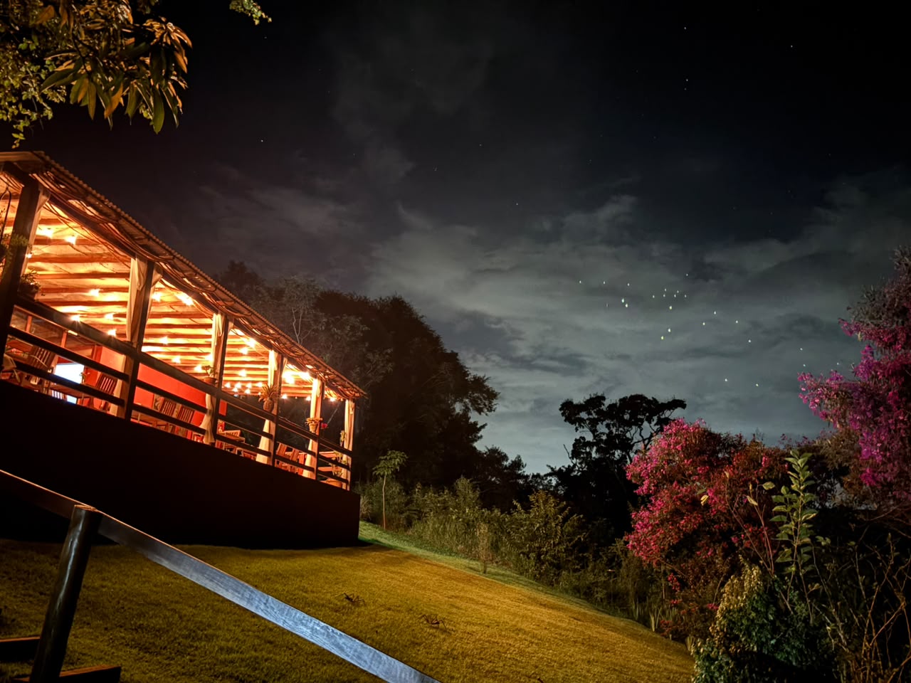 Illuminated veranda under a starry sky