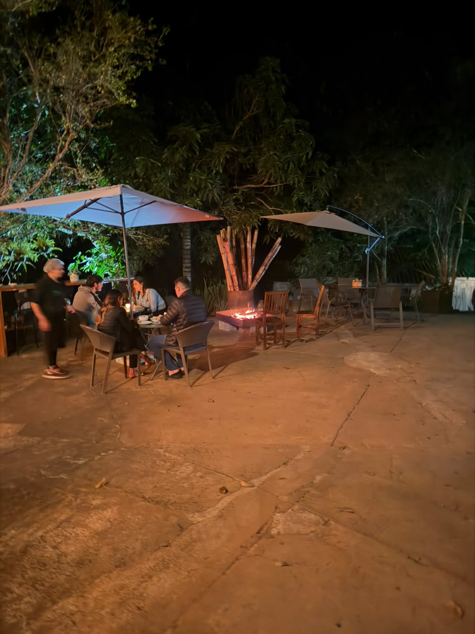Guests gathered around the fire pit at night