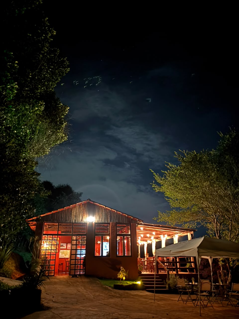 The inn's facade at night with warm lights